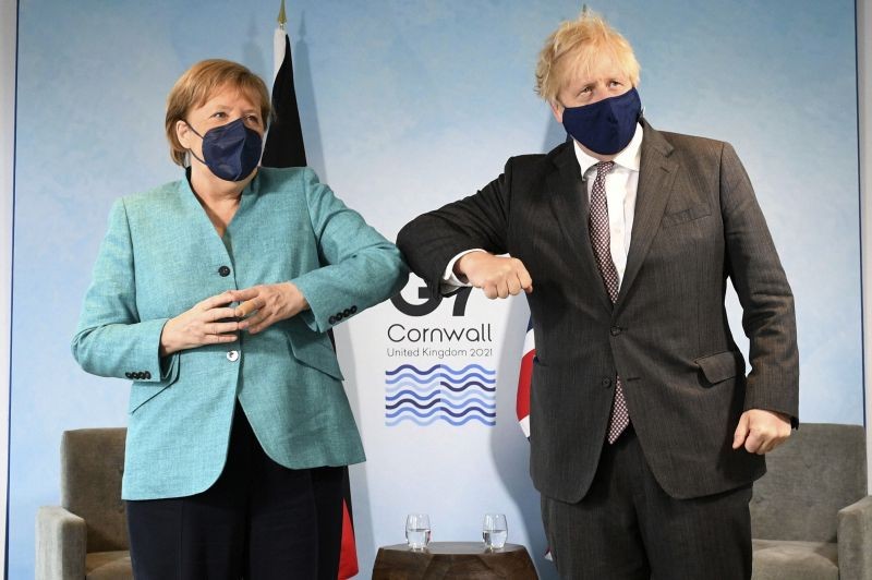 Britain's Prime Minister Boris Johnson, right, greets German Chancellor Angela Merkel ahead of a bilateral meeting during the G7 summit in Cornwall, England on June 12. (AP/PTI Photo)