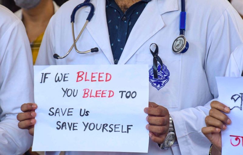 A doctor of Indian Medical Association (IMA) holds a placard during a nationwide protest, demanding a central law to protect doctors against violence, in Guwahati on June 18, 2021. (PTI Photo)