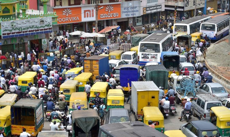 Commuters stuck in a traffic jam at city market area following ease in COVID-induced restrictions, in Bengaluru on June 28, 2021. (PTI Photo)