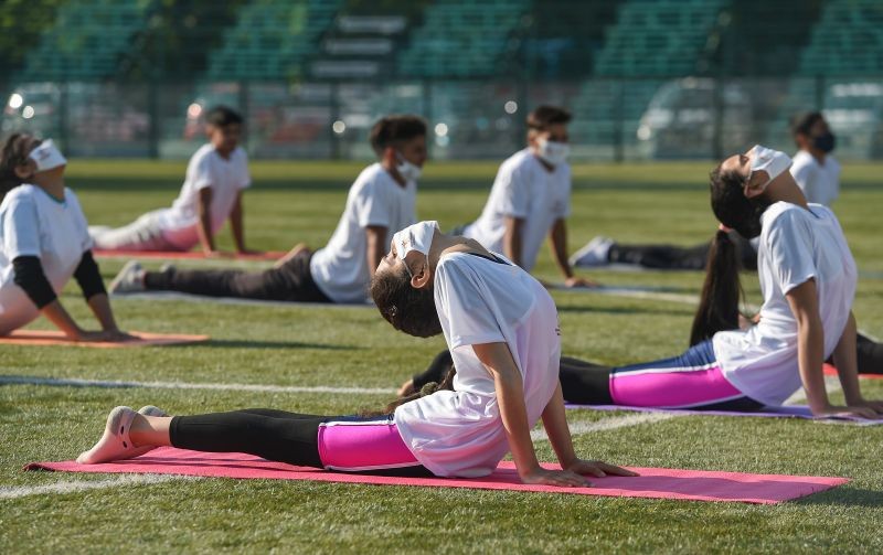 Students perform Yoga on the occasion of International Day of Yoga in Srinagar on June 21. (PTI Photo)