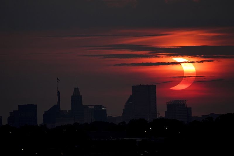 Arbutus: A partial solar eclipse rises over the Baltimore skyline, Thursday, June 10, 2021, seen from Arbutus, Md.  AP/PTI