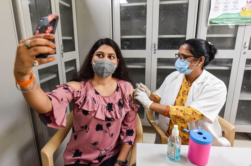 Prayagraj: A young woman takes a selfie while receiving a dose of COVID-19 vaccine at Moti Lal Nehru Medical College vaccination center, in Prayagraj, Thursday, June 24, 2021. (PTI Photo)