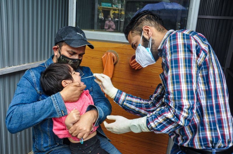 A health worker takes swab sample of a child for COVID-19 test, at Regional Hospital in Kullu on June 16, 2021. (PTI Photo)