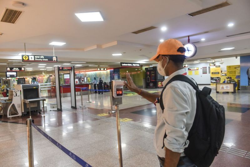 A man checks his temprature in a metro station as the service resumed after unlocking process of Covid-19 lockdown began in a phased manner, in Lucknow on June 9, 2021. (PTI Photo)