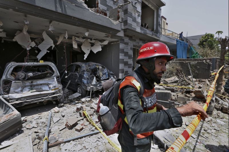 A rescue worker examine the site of explosion in Lahore, Pakistan on June 23, 2021. A powerful explosion ripped through a residential area in the eastern city of Lahore on Wednesday, killing few people and injuring some others, police and rescue officials said. (AP/PTI Photo )