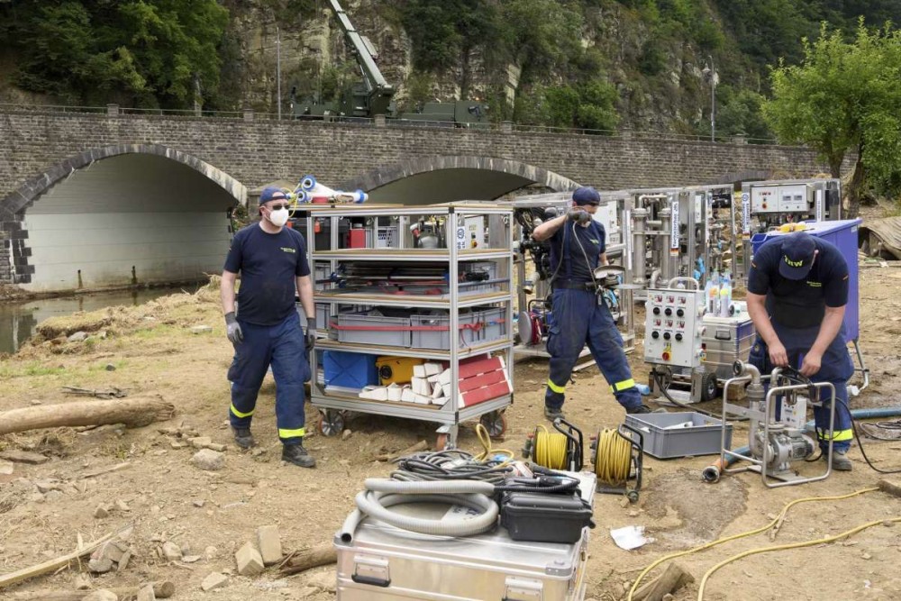 Volunteers dismantle a drinking water treatment plant in order to rebuild it on higher ground in Schuld, Germany, Thursday July 22, 2021. More rain is forecast for the region over the coming weekend. In the flood disaster area of Erftstadt-Blessem, some residents are being allowed back into their homes to clear debris after heavy rains caused devastating floods. (Thomas Frey/dpa via AP)Thomas Frey/AP