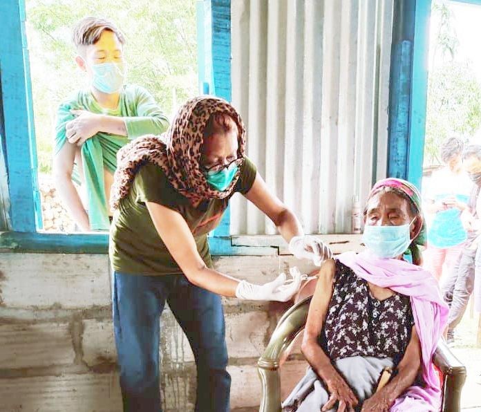 An 87-year old woman of Sumi Settsü Village, Akuluto block receiving her first dose of COVID-19 vaccination on June 12. (Photo Courtesy: IEC Bureau, CMO Office Zunheboto)