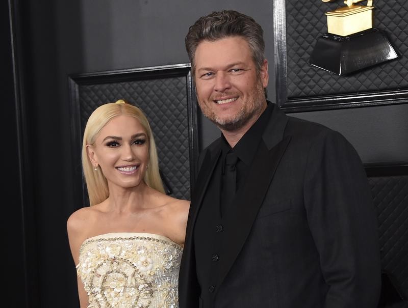 FILE - In this Jan. 26, 2020, file photo, Gwen Stefani, left, and Blake Shelton arrive at the 62nd annual Grammy Awards in Los Angeles. “The Voice” coaches Stefani and Shelton celebrated their nuptials over the Fourth of July holiday during a weekend wedding in Oklahoma. Images were posted Monday, July 5, 2021, of their wedding. (Photo by Jordan Strauss/Invision/AP, File)