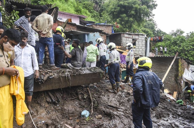 Firemen and rescue workers after a wall collapsed on some shanties in Chembur's Bharat Nagar area due to a landslide, in Mumbai on July 18, 2021. (PTI Photo)