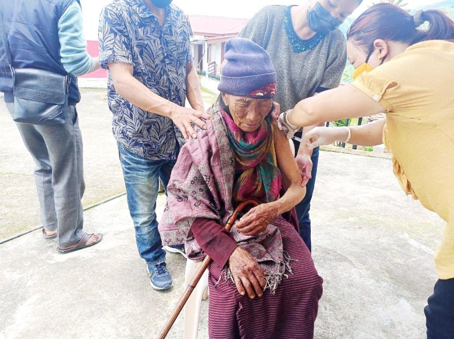 An 80 year-old woman receiving the 1st dose of COVID 19 vaccine at Khukishe village, Aghunato block under Zunheboto district on July 11. (Photo Courtesy: IEC Bureau, CMO Office Zunheboto/For representational purpose only)