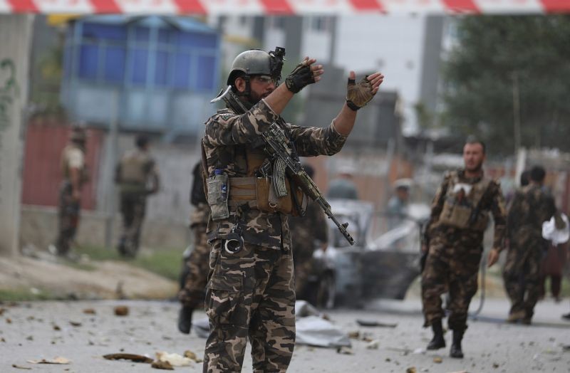 Security personnel inspect a damaged vehicle which was firing rockets in Kabul, Afghanistan on July 20, 2021. At least three rockets hit near the presidential palace on Tuesday shortly before Afghan President Ashraf Ghani was to give an address to mark the Muslim holiday of Eid-a-Adha.  (AP/PTI Photo)
