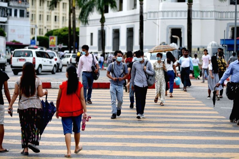 People walk across a road in Yangon, Myanmar, on July 10, 2020. (IANS File Photo)