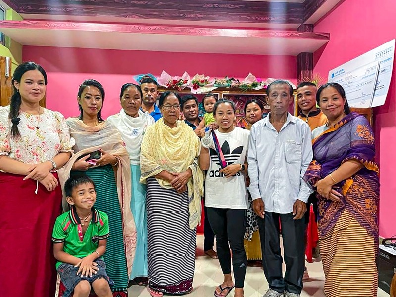 **EDS: TWITTER IMAGE POSTED BY @mirabai_chanu ON WEDNESDAY, JULY 28, 2021.** Imphal: Silver medalist in Tokyo Olympics, Weighlifter Saikhom Mirabai Chanu with her family at her residence in Nongpok Kakching village near Imphal. (PTI Photo)