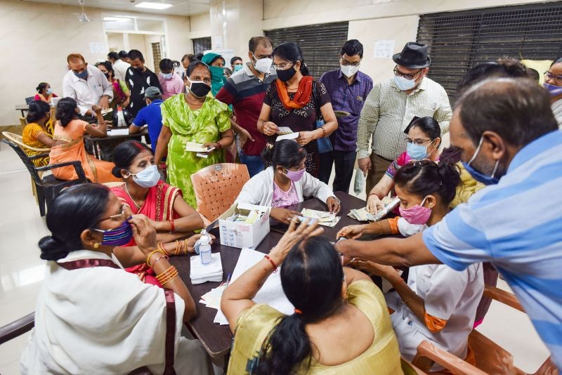 Beneficiaries register for COVID-19 vaccine dose, at Moti Lal Nehru Medical College in Prayagraj, Thursday, July 1, 2021. (PTI Photo)