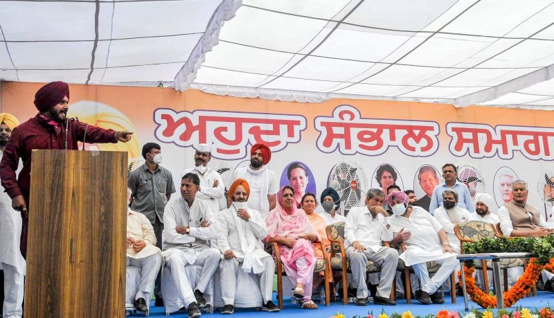 Newly appointed Punjab Congress President Navjot Singh Sidhu addresses the gathering at Punjab Congress Bhawan in Chandigarh on July 23. Punjab CM Capt. Amrinder Singh and party leader Harish Rawat are also seen. (PTI Photo)