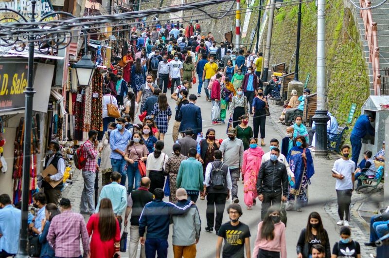 Tourists walk in a crowded market area, at Mall Road in Shimla on July 15. (PTI Photo)