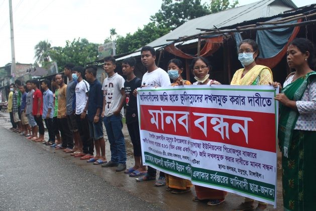 Indigenous people form a human chain in Tangail district, Bangladesh as they demand legal rights to their ancestral forest land. (IPS Photo)