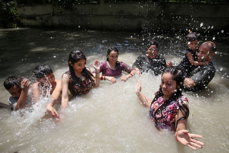 People enjoy at Ranbir canal on a hot summer day in Jammu on July 4, 2021. (PTI Photo)