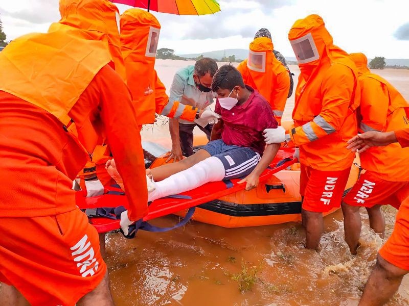 NDRF team evacuate a patient during a rescue operation at a fooded area after rain in Kolhapur. (PTI Photo)