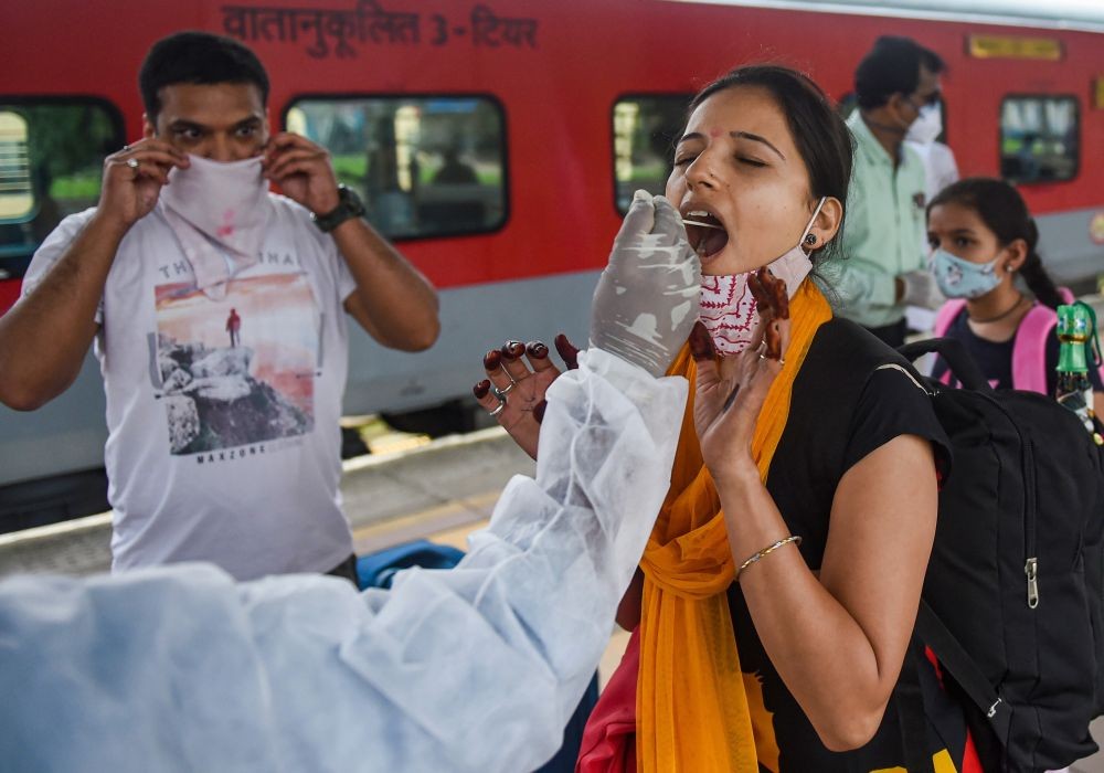 Mumbai: A BMC health worker collects swab sample of a passenger for COVID-19 test, at a station in Mumbai, Wednesday, June 30, 2021.  (PTI Photo/Shashank Parade)