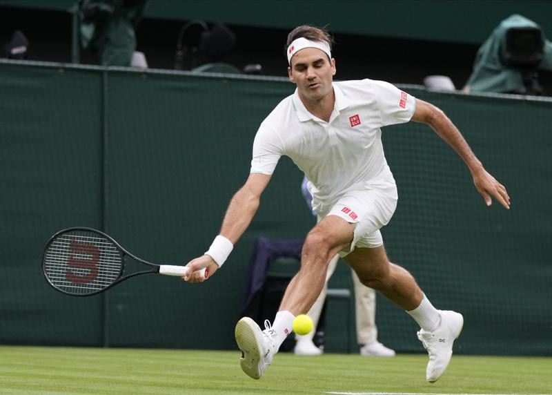 Switzerland's Roger Federer plays a return to Adrian Mannarino of France during the men's singles first round match against on day two of the Wimbledon Tennis Championships in London, Tuesday June 29, 2021. (AP Photo/Kirsty Wigglesworth)