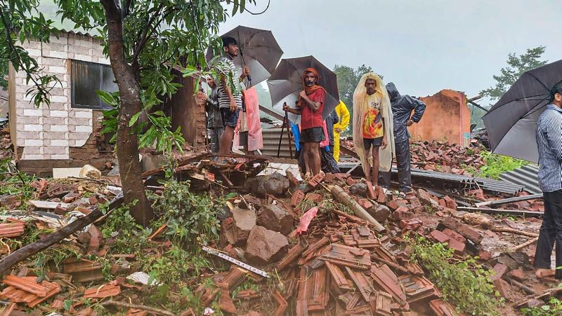 Locals at the site after several people died in a landslide at Taliye village in Satara distric on July 23, 2021. (PTI Photo)