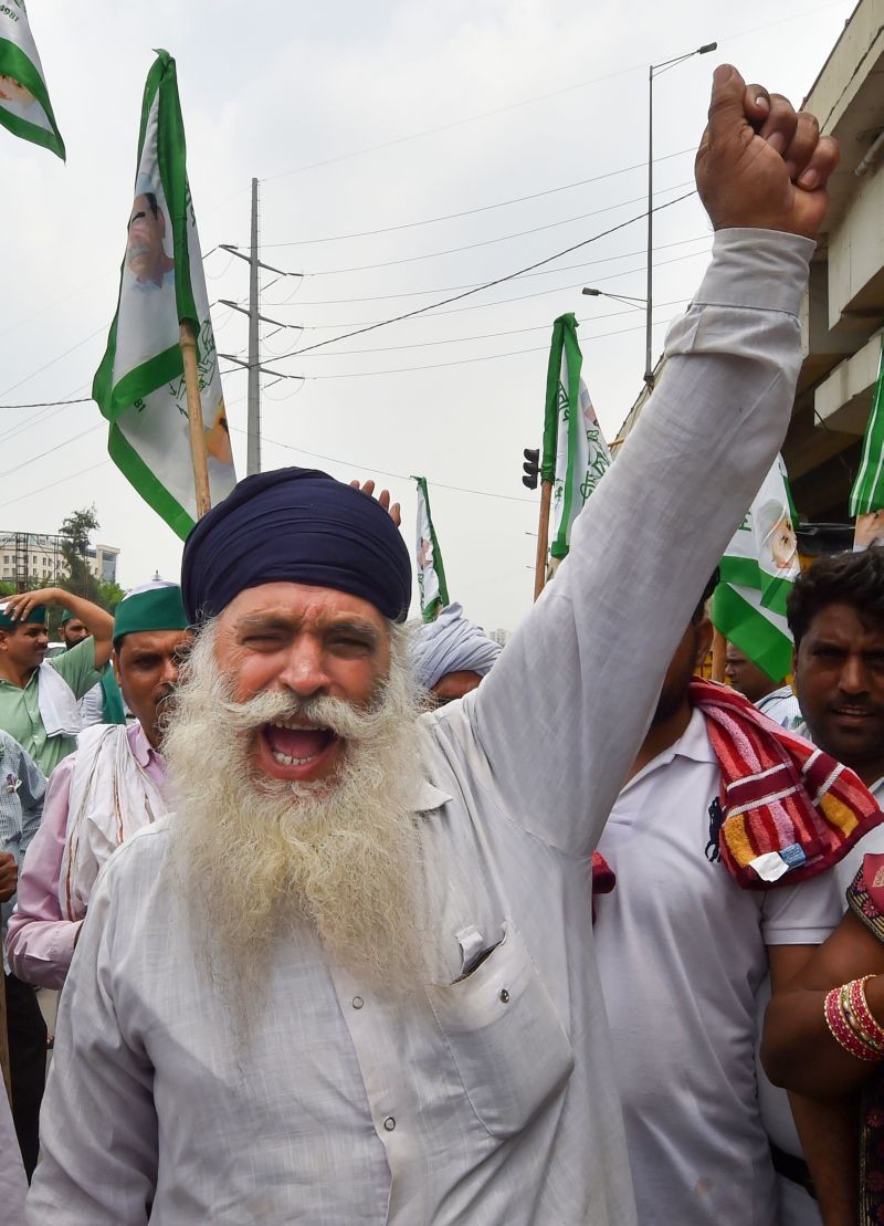 A farmer raises slogan during their protest against three farm reform laws, at Ghazipur border in New Delhi on July 21, 2021. Farmers are scheduled to protest march towards Parliament against three farm laws on Thursday. (PTI Photo)