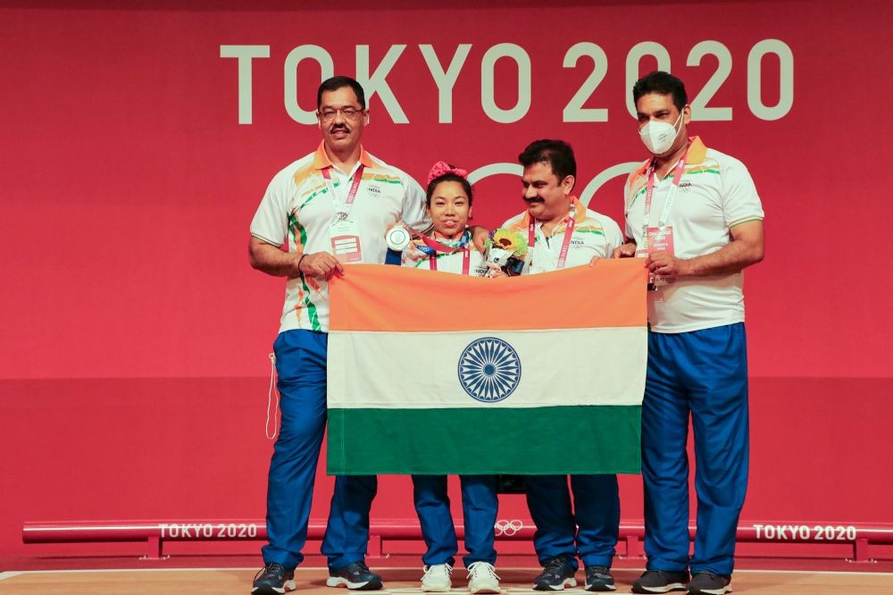 **EDS: TWITTER IMAGE POSTED BY @mirabai_chanu ON SATURDAY, JULY 24, 2021** Tokyo: Weightlifter Mirabai Chanu with coach Vijay Sharma after winning silver medal at the T0kyo Olympics. (PTI Photo)