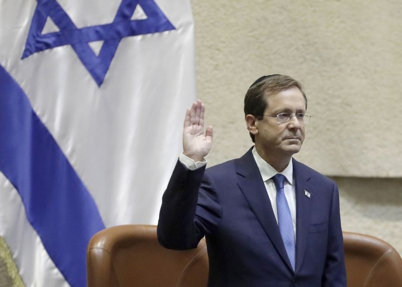 Israel's President-elect Isaac Herzog raises his hand during his sworn in ceremony in the Knesset in Jerusalem on July 7. (AP/PTI Photo)