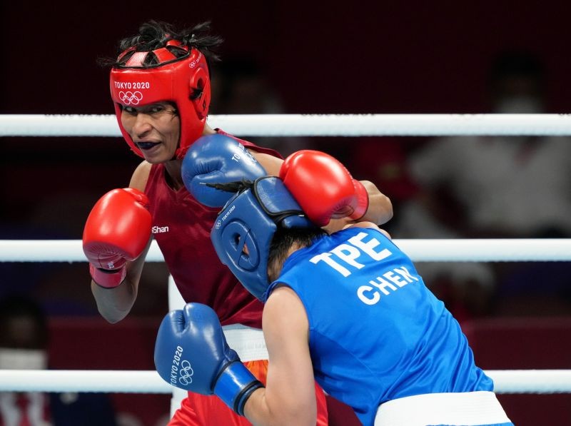 India's Lovlina Borgohain lands a punch on Chen Nien-Chin of Chinese Taipei during women's welterweight (64-69kg) category boxing match, at the Summer Olympics 2020 in Tokyo on July 30, 2021. Borgohain won 4-1. (PTI Photo)