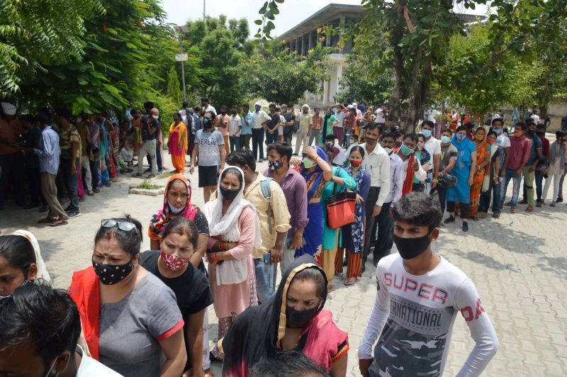 Beneficiaries wait in queues to receive COVID-19 vaccine dose during a Maha Vaccine Campaign by BJP, at Indirapuram Primary School in Ghaziabad on July 23, 2021. (PTI Photo)