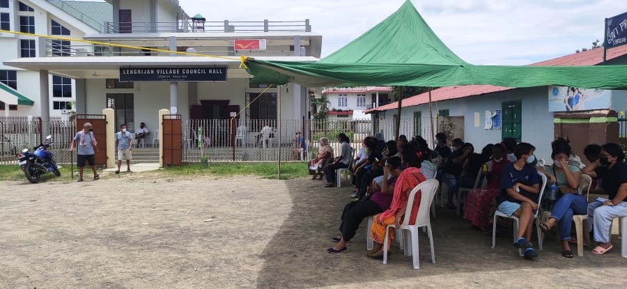 Beneficiaries wait outside Lengrijan Village Council Hall in Dimapur to avail COVID-19 vaccination on July 5. (Morung Photo by Manen Aier)