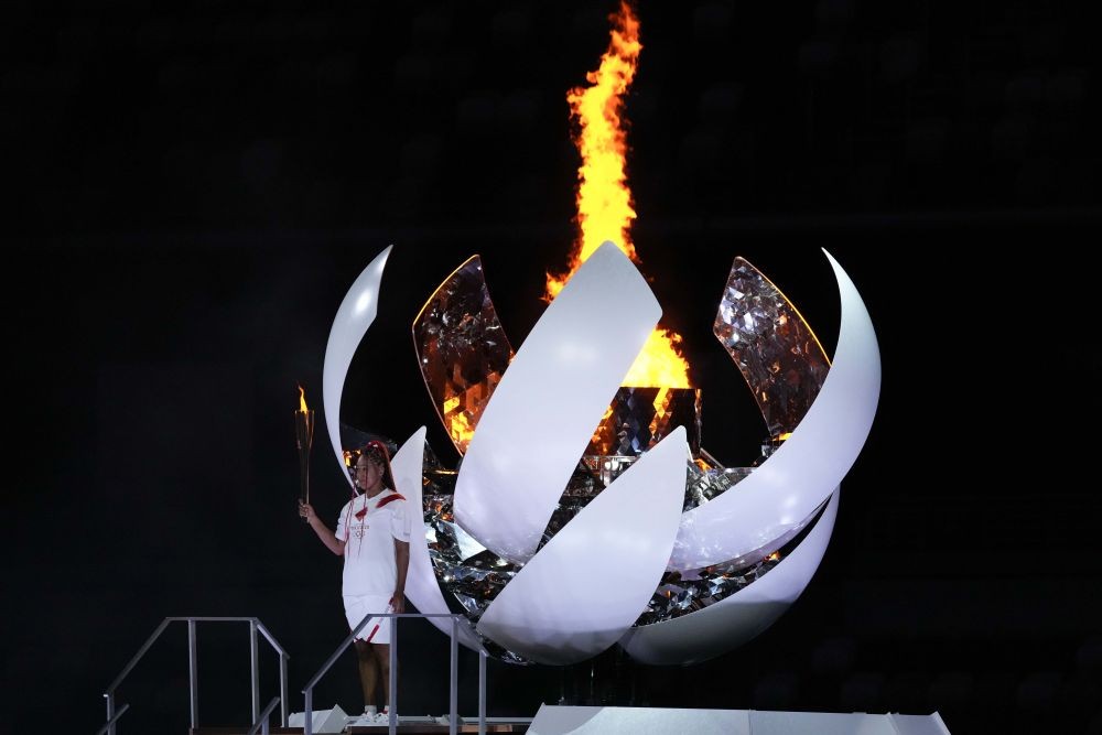 Tokyo: Japan's Naomi Osaka reacts after lighting the cauldron during the opening ceremony in the Olympic Stadium at the 2020 Summer Olympics, Friday, July 23, 2021, in Tokyo, Japan. AP/PTI Photo