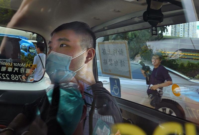 In this July 6, 2020, file photo, Tong Ying-kit arrives at a court in a police van in Hong Kong. Tong was arrested in July 2020 after driving his motorbike into a group of police officers while carrying a flag bearing the protest slogan “Liberate Hong Kong." He was charged with inciting separatism and terrorism. (AP File Photo)