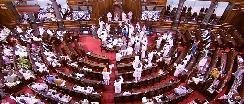 Members protest in the well of the Rajya Sabha during the Monsoon Session of Parliament, in New Delhi on July 28. (RSTV/PTI Photo)