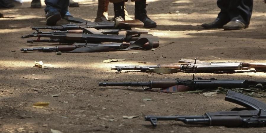 Guns that belonged to child soldiers lie on the ground at a release ceremony. AP File Photo