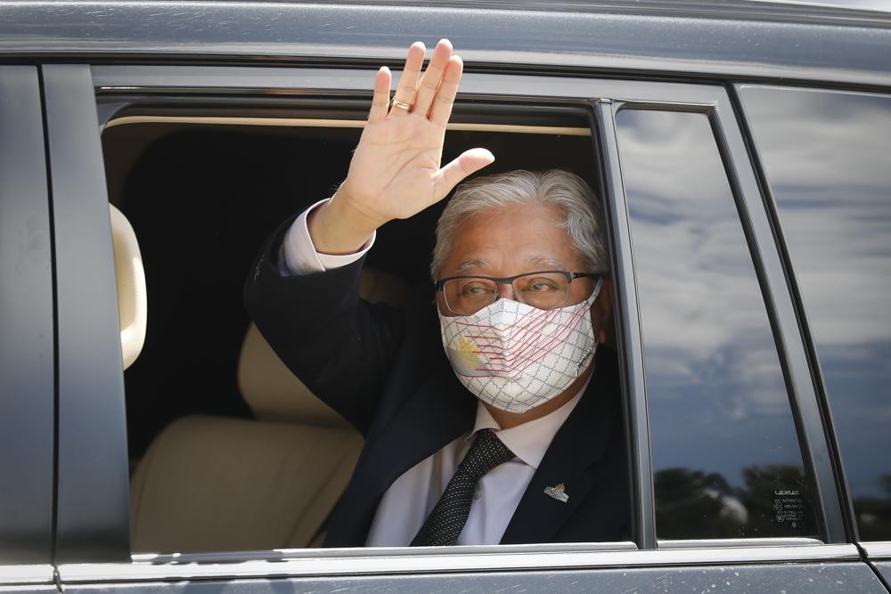 Former Deputy Prime Minister Ismail Sabri Yaakob waves to media as he leave after meeting with the King at national palace in Kuala Lumpur, Malaysia, Thursday, Aug. 19, 2021. Yaakob appeared to have won majority support to be Malaysia's new leader. His backers have been summoned to the palace Thursday to verify to the king they support him. (AP Photo/FL Wong)