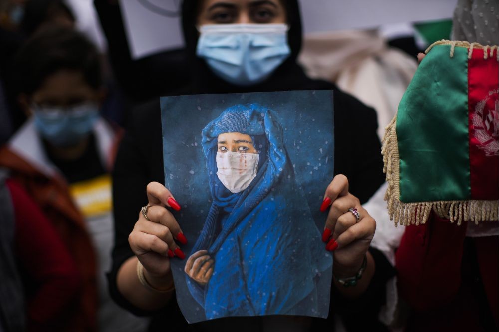 Brussels: A woman holds a photograph during a protest to raise awareness regarding the situation in Afghanistan outside EU headquarters in Brussels, Wednesday, Aug. 18, 2021. The European Union has no immediate plans to recognize the Taliban after their sweeping victory in Afghanistan but will talk with the militants to ensure that European nationals and Afghans who have worked with the EU can leave safely, the bloc's top diplomat said Tuesday. AP/PTI(