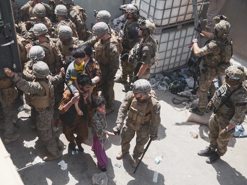 In this Aug. 20, 2021, photo provided by the U.S. Marine Corps, U.S. Marines and Norweigian coalition forces assist with security at an Evacuation Control Checkpoint ensuring evacuees are processed safely during an evacuation at Hamid Karzai International Airport in Kabul, Afghanistan. (AP Photo))