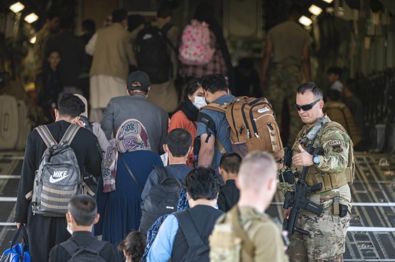 In this image provided by the U.S. Air Force, U.S. Air Force airmen guide evacuees aboard a U.S. Air Force C-17 Globemaster III at Hamid Karzai International Airport in Kabul, Afghanistan on Aug. 24, 2021. (AP/PTI Photo)