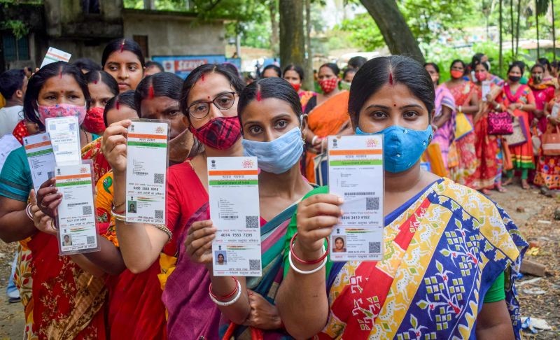 Beneficiaries show their Aadhaar Card as they wait in a queue to receive COVID-19 vaccine dose, at a vaccination centre in Nadia district on August 16, 2021. (PTI Photo)