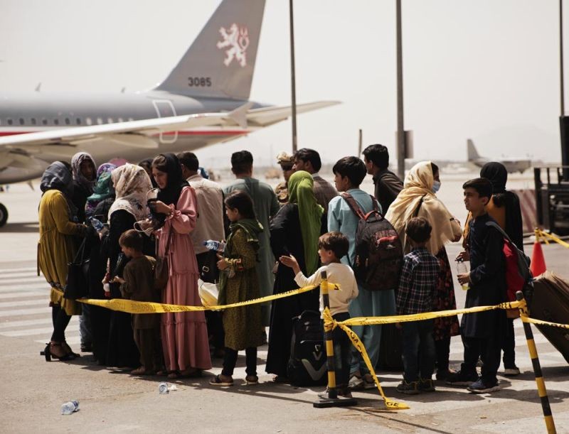 In this photo provided by the U.S. Marine Corps, civilians prepare to board a plane during an evacuation at Hamid Karzai International Airport, Kabul, Afghanistan on August 18, 2021. (AP Photo)