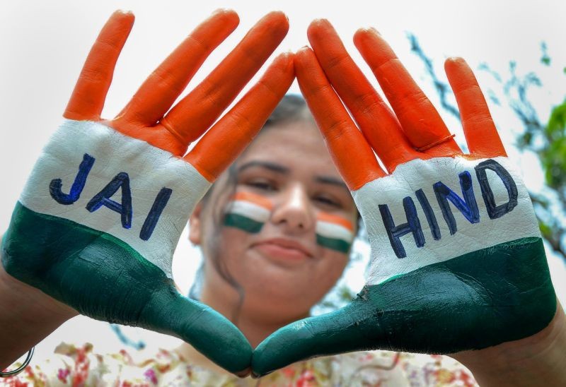 Amritsar: A girl paints her face and hands with tricolour pose for photographs on the eve of Independence Day celebrations, in Amritsar, Saturday, Aug. 14, 2021. (PTI Photo)