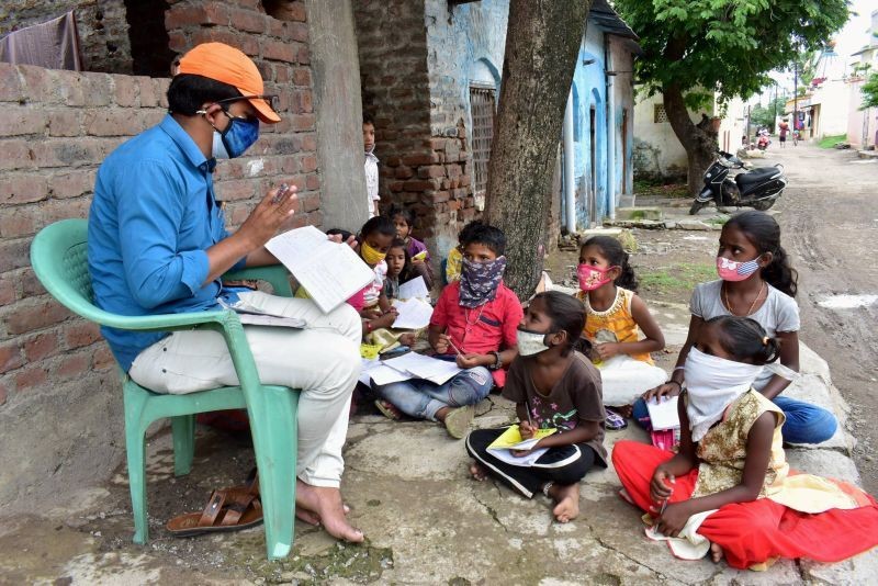 A Municipal Corporation school teacher teaches students, who cannot afford online classes, in Solapur. (PTI File Photo)