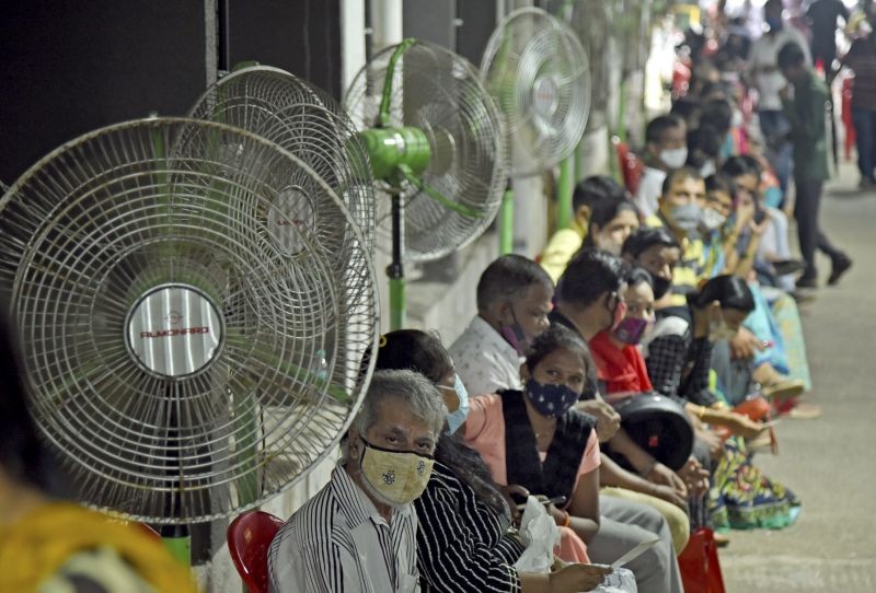 Beneficiaries wait in a queue to receive a dose of COVID-19 vaccine at NMMC Hospital in Navi Mumbai on August 30. (PTI Photo)