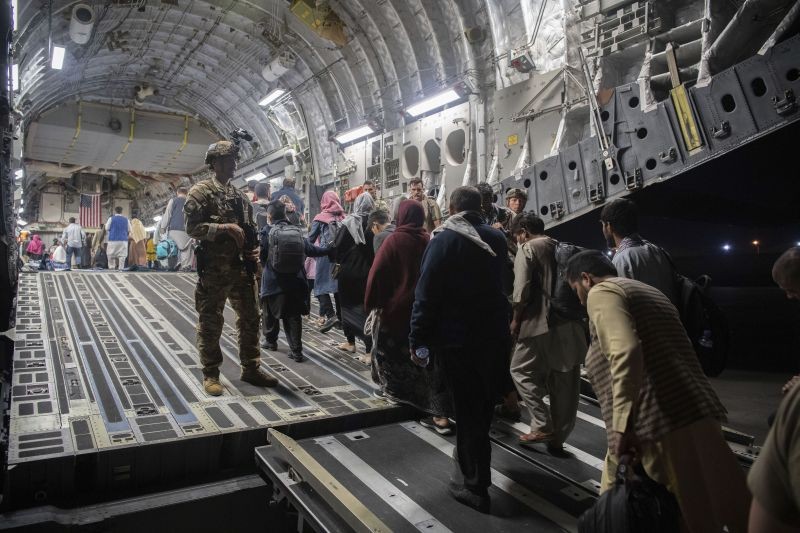 In this Aug. 22, 2021, photo provided by the U.S. Air Force, Afghan passengers board a U.S. Air Force C-17 Globemaster III during the Afghanistan evacuation at Hamid Karzai International Airport in Kabul, Afghanistan. (AP/PTI Photo)