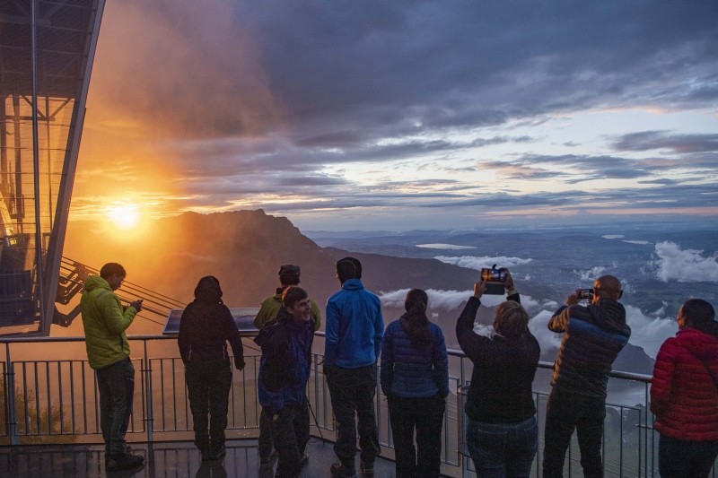 Stanserhorn : Tourists enjoy the sunset on the Stanserhorn Mountain, with Mount Pilatus and Lake Lucerne in the background, Sunday, Aug. 1, 2021, near Stans, Switzerland. AP/PTI