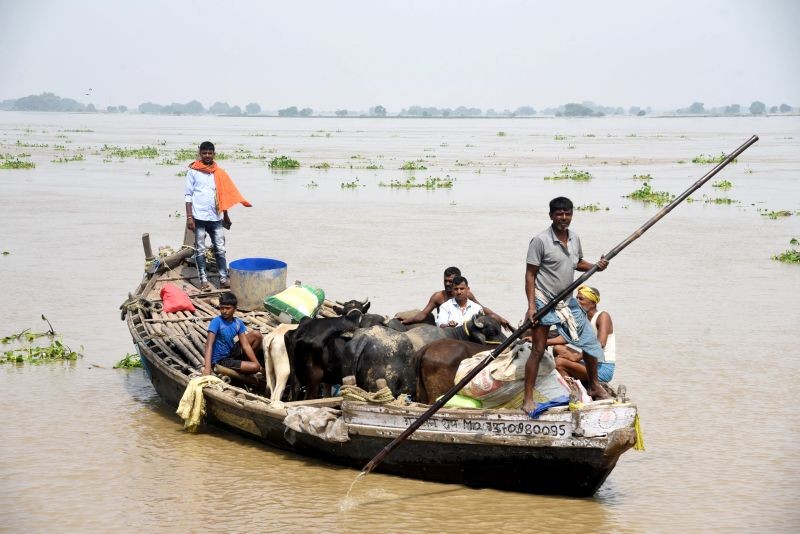 Patna: Villagers of Nakta Diyara use a boat to shift to a safe place, in Patna, Saturday, Aug. 14, 2021. (PTI Photo)