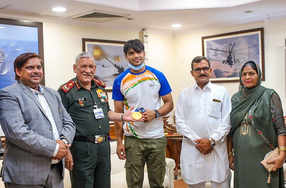 **EDS: TWITTER IMAGE POSTED BY @adgpi** New Delhi: Chief of Defence Staff General Bipin Rawat with Subedar Neeraj Chopra who won Gold medal in Javelin throw event of the Tokyo Olympics, in New Delhi, Tuesday, Aug 10, 2021. Neeraj's parents are also seen. (PTI Photo)