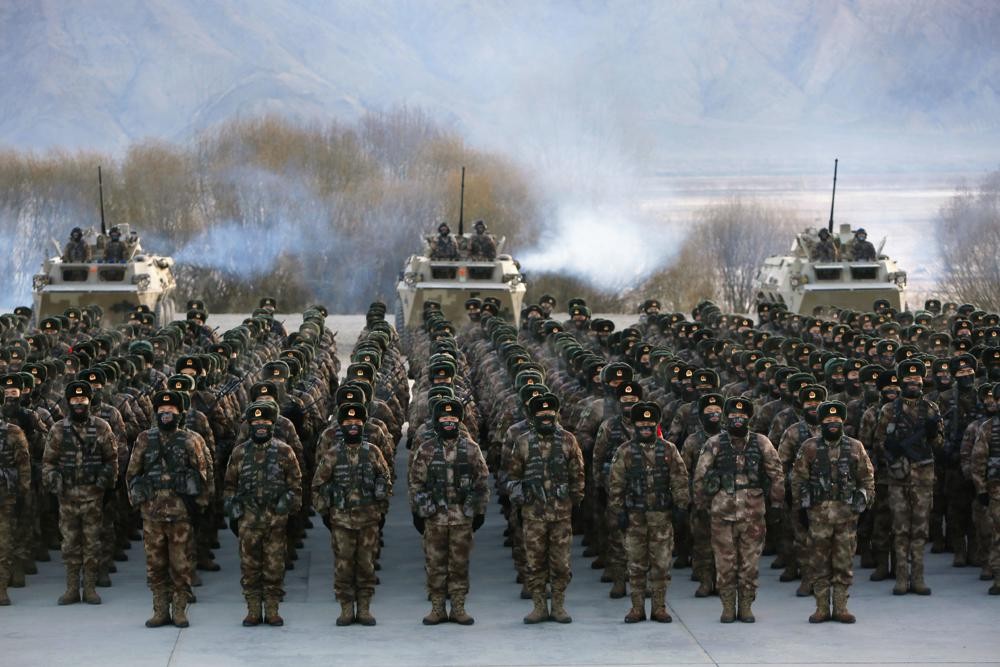 FILE - In this Jan. 4, 2021, file photo, Chinese soldiers rally while training in -20 degrees Celsius (-4 Fahrenheit) conditions in Kashgar in northwestern China's Xinjiang Uighur Autonomous Region. China appointed on Friday, Aug. 6, 2021 a new military commander in restive Xinjiang where authorities have locked up more than a million members of Muslim minorities in what they call a bid to curb terrorism and radicalism. (Chinatopix via AP, File)